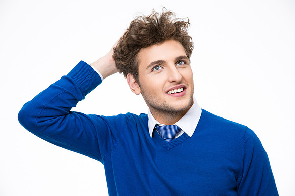 Portrait of a happy thoughtful business man looking up