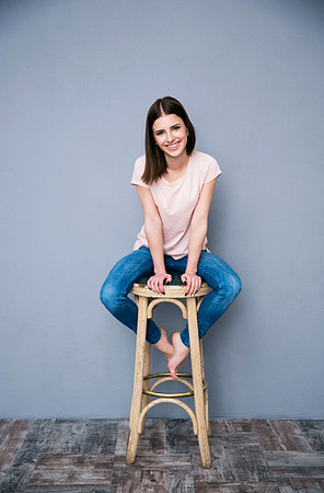 Portrait of a smiling woman sitting on the chair